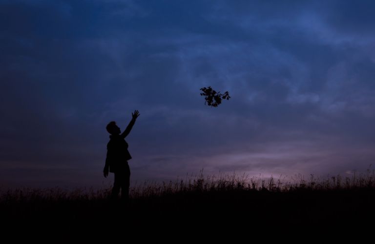 a man letting go of balloons