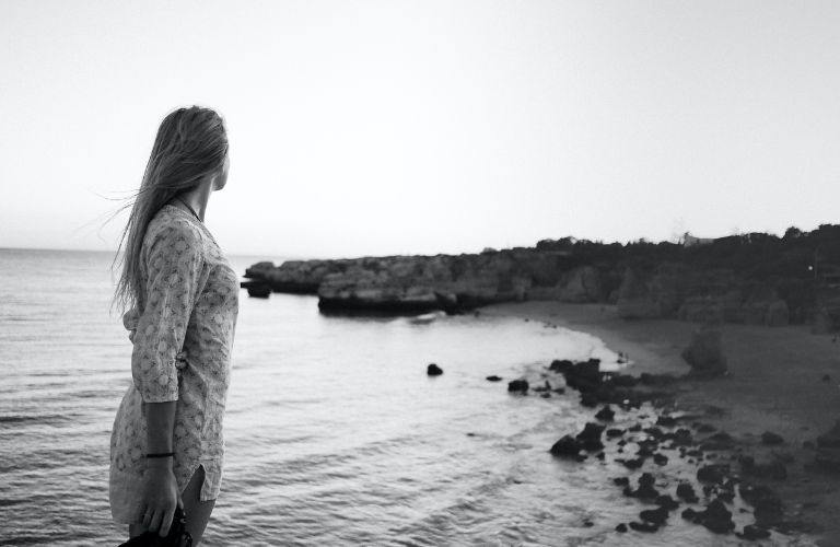 a woman looking back in a beach