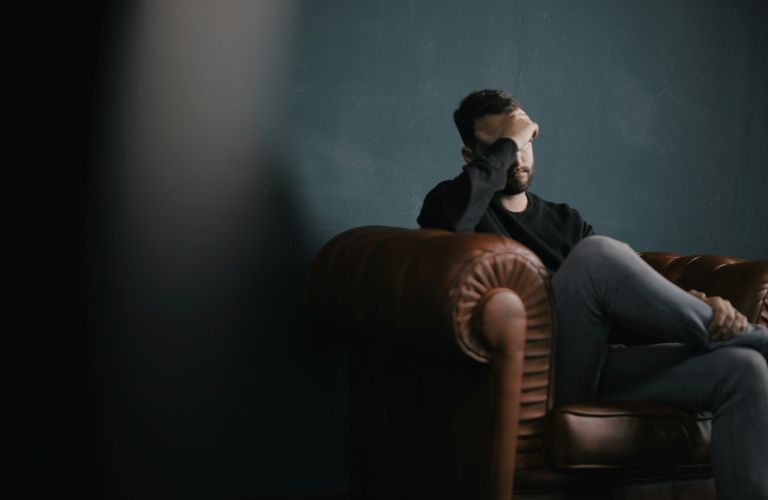 A man sitting on a chair worried