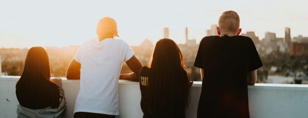 4 young people on a balcony